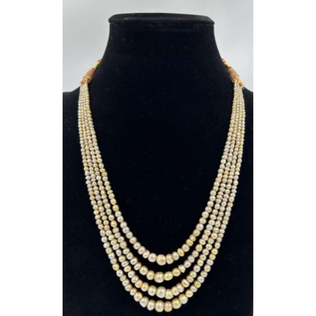 Four strands of high quality Basra Pearls.