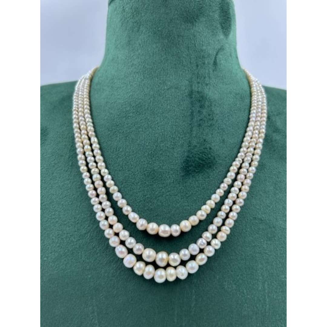Three strands of superior quality Basra Pearls.